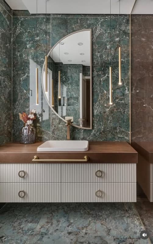 Green-toned bathroom tile and countertop installation